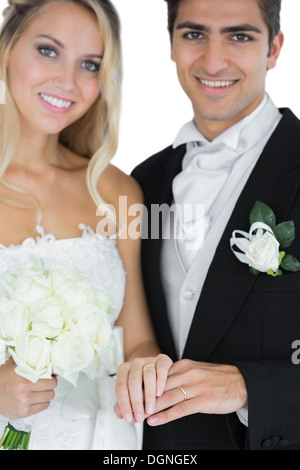 Young married couple posing wearing wedding rings Stock Photo