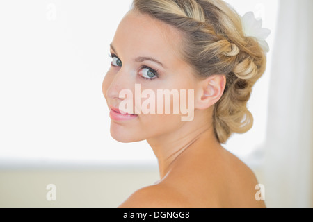 Attractive young bride looking over shoulder Stock Photo