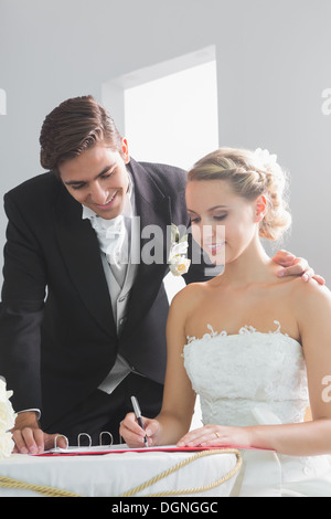 Young beautiful bride signing wedding register Stock Photo
