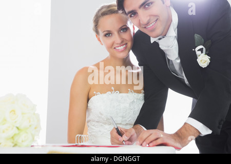 Happy bridegroom signing wedding contract