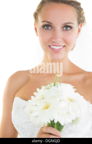 Gorgeous blonde bride posing holding a bouquet Stock Photo