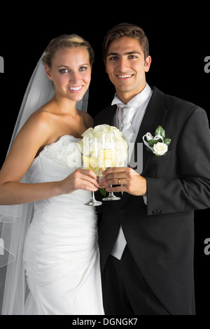 Content married couple posing holding champagne glasses Stock Photo
