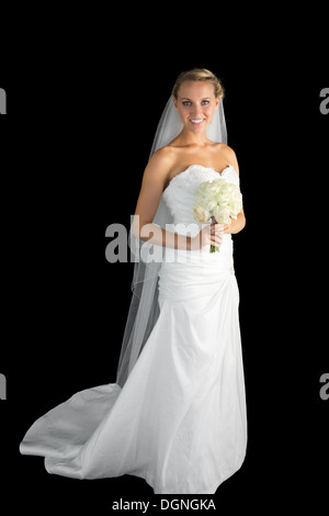 Gorgeous young bride posing holding a bourquet Stock Photo