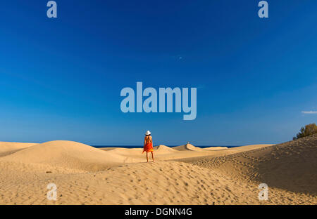 Woman in front of sand dunes of Maspalomas, Gran Canaria, Canary Islands, Spain Stock Photo
