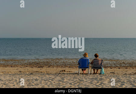 Couple sitting on the beach, Rota, Andalusia, Spain, Europe Stock Photo