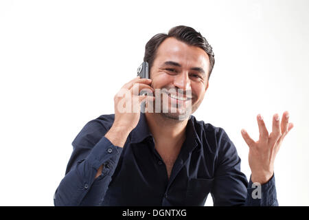 Smiling man talking on a mobile phone Stock Photo