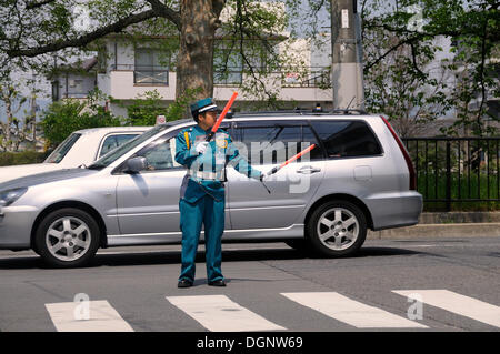 Typical police officer directing traffic in a parking lot, Kyoto, Japan, East Asia, Asia Stock Photo