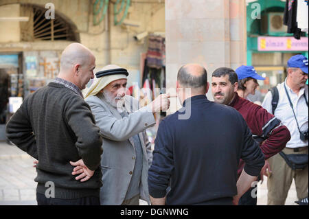 Palestinian men in conversation at the Muristan, Christian Quarter, Jerusalem, Israel, Western Asia, Middle East Stock Photo