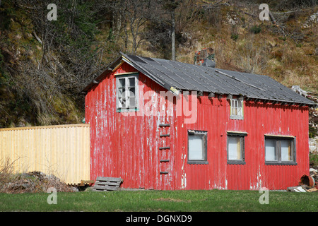 Small abandoned red wooden rural Norwegian house Stock Photo