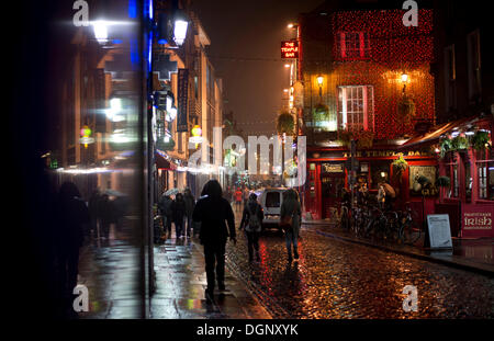 Passers-by in the street outside The Temple Bar, at night, Dublin, Leinster, Ireland Stock Photo