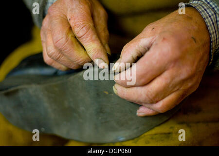 Shoemaker working Stock Photo