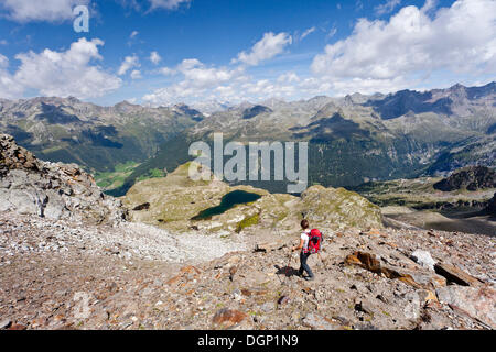 Climber descending from Schneebiger Nock mountain, Rieserfernergruppe mountain group, Puster valley, Lake Grosser Malersee below Stock Photo