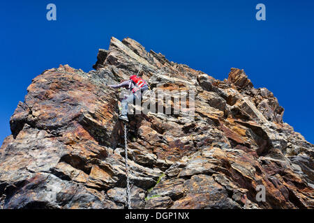 Mountain climber during the ascent of Schneebiger Nock Mountain on a climbing route in the Rieserferner Group in the Puster Stock Photo