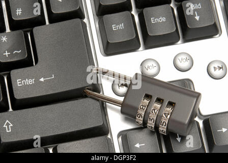 Enter key on a computer keyboard with a combination lock, symbolic image for a computer lock Stock Photo