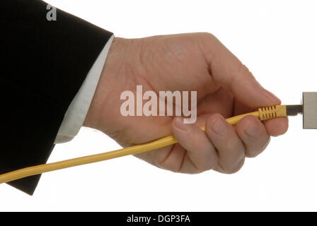 Business man's hand with a lan cable, symbolic image for the internet Stock Photo