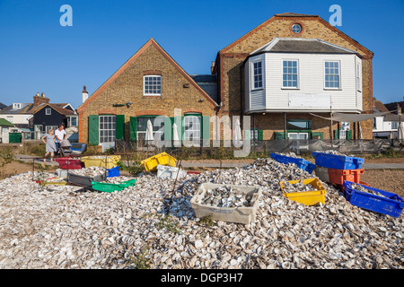 England, Kent, Whitstable, Piles of Oyster Shells and Waterfront Buildings Stock Photo