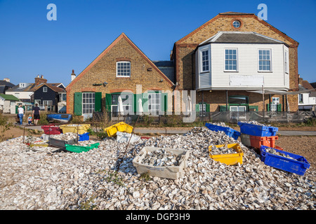 England, Kent, Whitstable, Piles of Oyster Shells and Waterfront Buildings Stock Photo