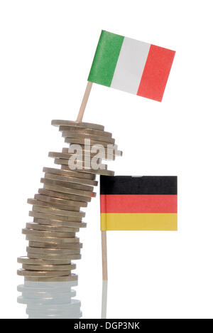 Wobbly stack of Euro coins supported by a German flag, an Italian flag on top, symbolic image for financial crisis of the Euro Stock Photo