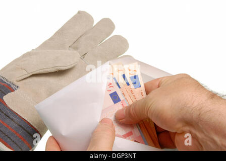 Worker with a pay envelope, money in an envelope Stock Photo