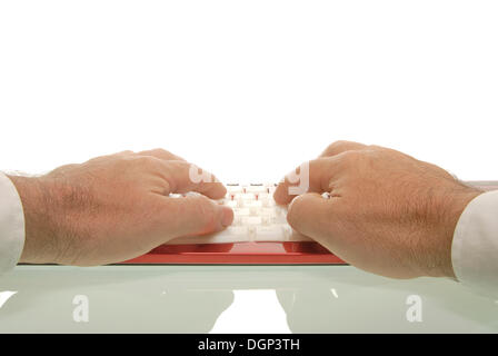 Man's hands on a red keyboard Stock Photo