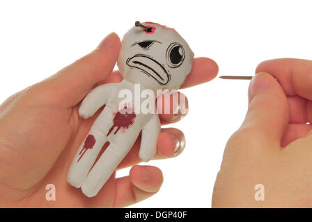 Woman's hands with a voodoo doll Stock Photo