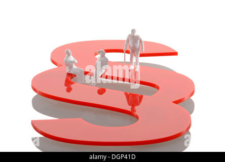 Three figurines of retired people sitting on a section sign, symbolic image for lawsuits in old age Stock Photo