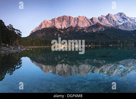 Eibsee Hotel and the mountains being reflected in the Eibsee Lake after sunset, Upper Bavaria Stock Photo