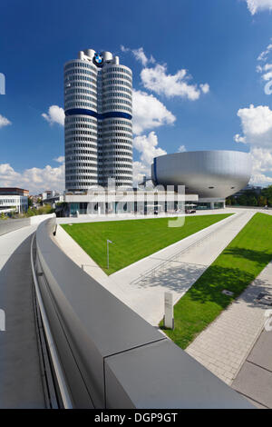 BMW Tower with the BMW Museum on Mittleren Ring, the central ring road near the Olympic Centre, Munich, Upper Bavaria, Bavaria Stock Photo