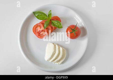 Plate with tomato, mozzarella and basil Stock Photo