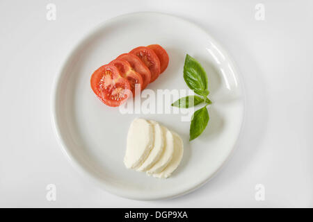 Plate with tomato, mozzarella and basil Stock Photo