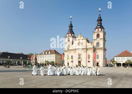 Priest and altar boys on their way to church on the marketplace, Ludwigsburg, Baden-Wuerttemberg Stock Photo