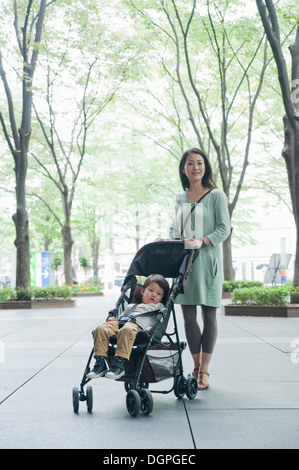 Mother with son sitting in stroller, portrait Stock Photo