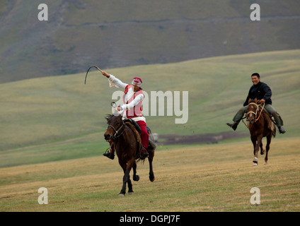 Man And Woman Playing Kyz Kuumai Horse Game, Saralasaz Jailoo, Kyrgyzstan Stock Photo