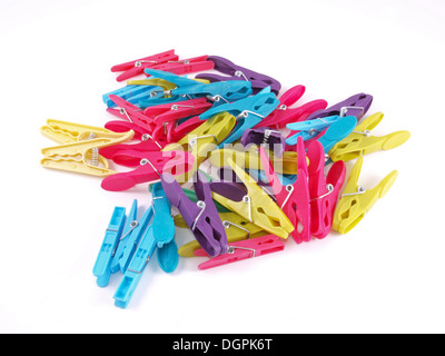 Multicolored plastic clothes pegs on a white background. Stock Photo