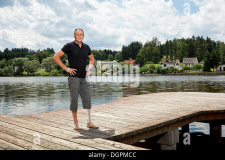 Man with a prosthetic leg standing on a jetty Stock Photo