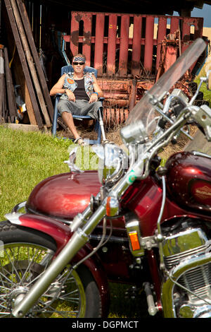 Biker with a prosthetic leg Stock Photo