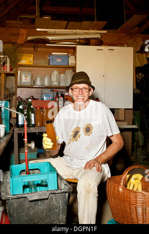 Man pasteurising apple juice Stock Photo