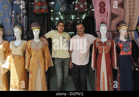 Father and son in front of their clothing store in Amman, Jordan, Middle East Stock Photo