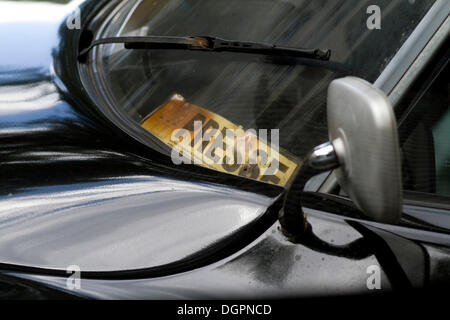 Yellowed press pass behind the windshield of a Citroen DS vintage car, Berlin Stock Photo