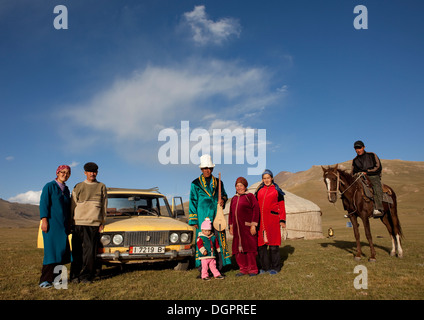 Family Gathered In Front Of Their Yurt And Car, Jaman Echki Jailoo Village, Song Kol Lake Area, Kyrgyzstan Stock Photo
