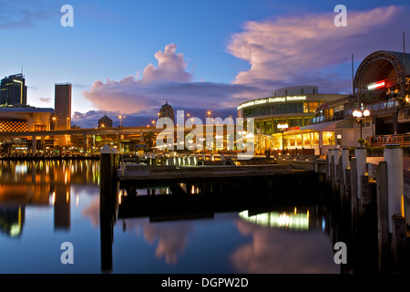 Dawn breaks over a stormy sky in Darling Harbour, Sydney, Australia. Stock Photo