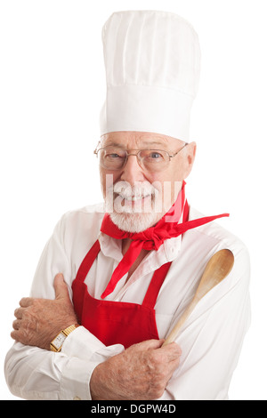 Handsome senior man in a chef's uniform, holding a wooden spoon. Isolated on white. Stock Photo