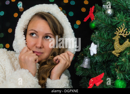 Attractive woman over christmas tree. Stock Photo