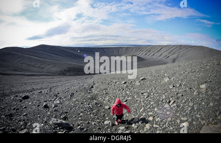 Such an astronaut on the moon, a young walker climbs the side of the volcano Hverfjall close to lake Myvatn in Iceland Stock Photo