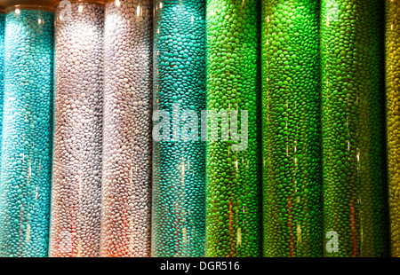 Multi coloured sweets in tall glass jar display Stock Photo