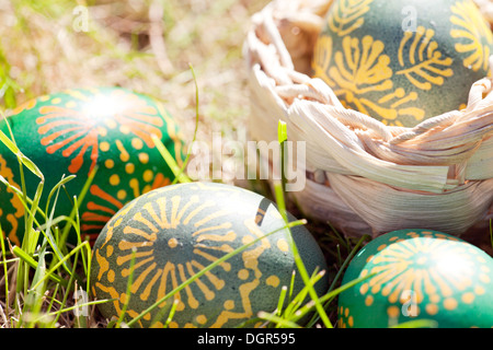 easter eggs decorated with bee wax on the grass Stock Photo