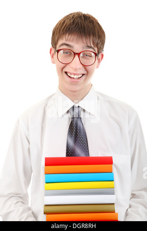 Cheerful student holding heavy pile of books standing in library Stock ...