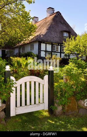 Half-timbered house behind a garden gate, Sieseby on the Schlei river, Thumby, Rendsburg-Eckernfoerde district Stock Photo