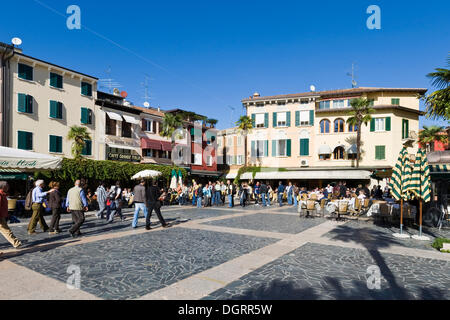 Tourists at a restaurant on the promenade in Sirmione, Lake Garda, Lago di Garda, Lombardy, Italy, Europe Stock Photo