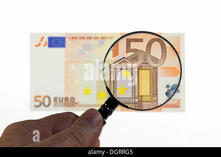 50 euro under a magnifying glass, symbolic image, observation of the euro Stock Photo